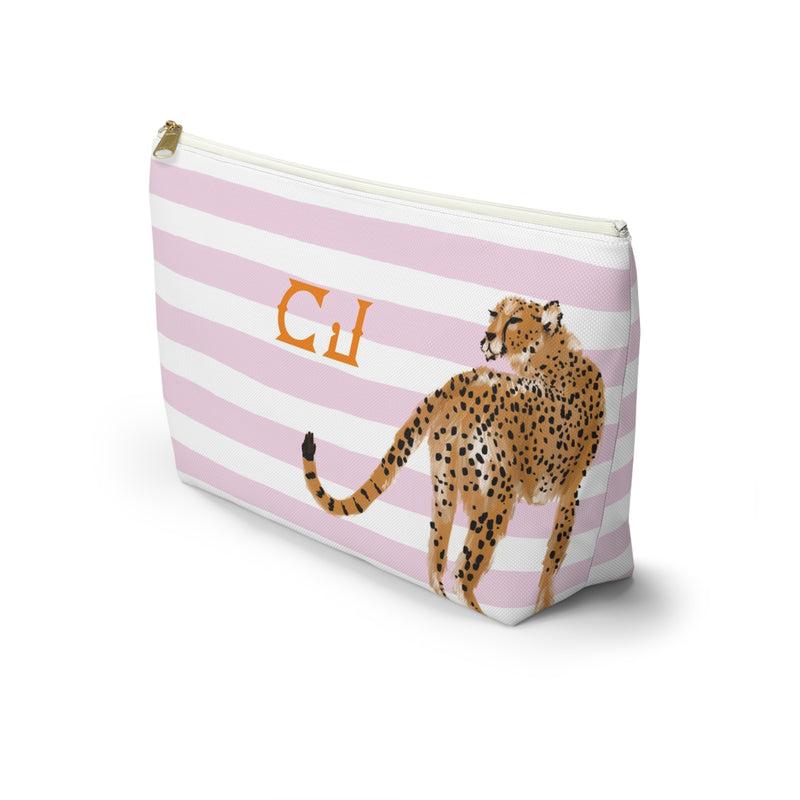 A pink and white striped cosmetic bag with a cheetah illustration and the initials 'CJ' printed on it.